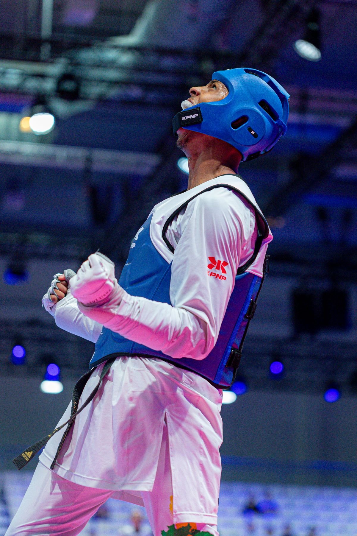 Taekwondo athlete celebrating a victory at an arena